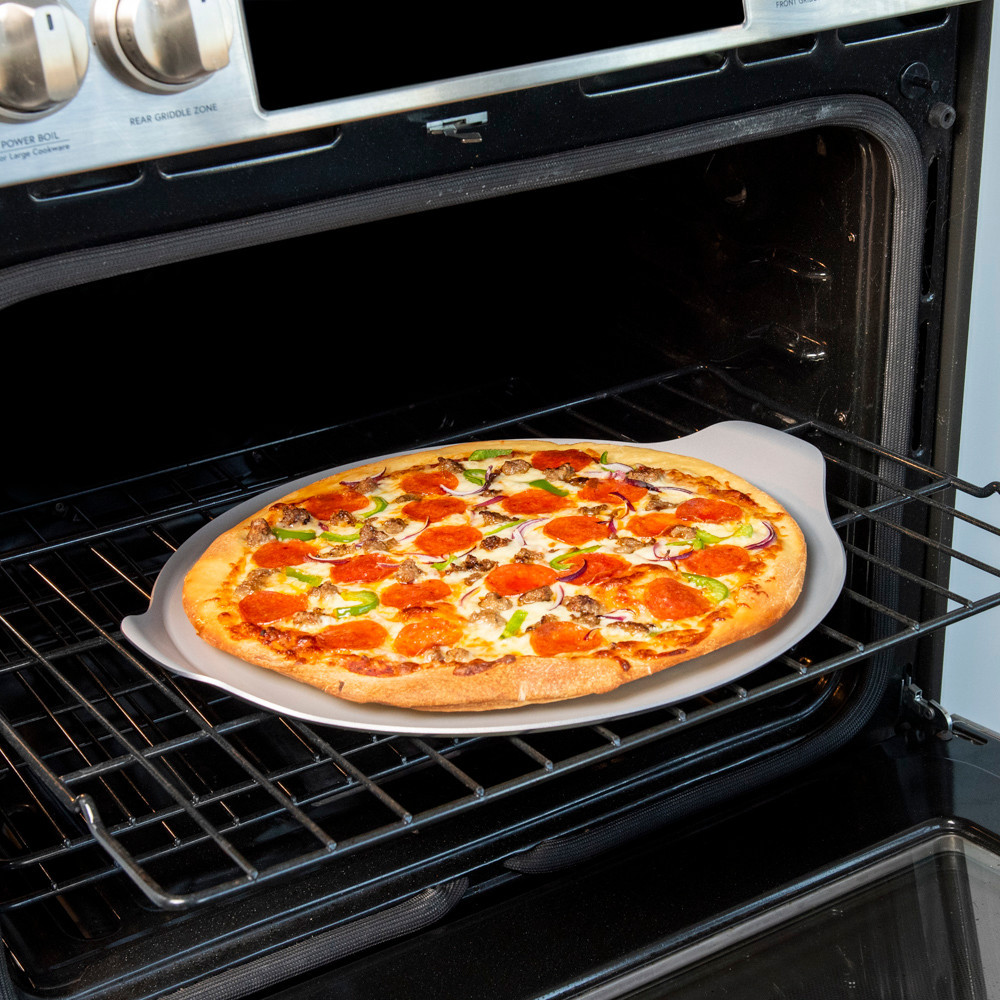 nordic ware aluminized steel pizza & baking steel pan on oven rack with baked pizza