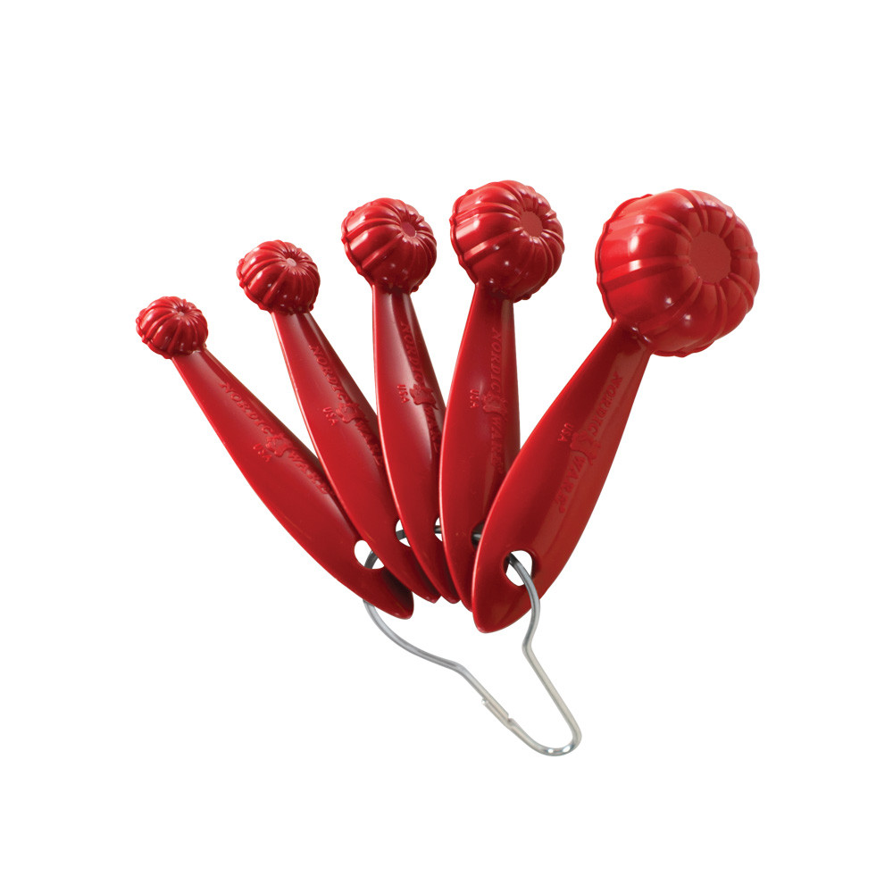 Set of 5 Nordic Ware Bundt measuring spoons in red, nested together showing fluted design