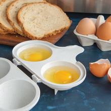 Two perfectly poached eggs with runny yolks in Nordic Ware aluminum egg poacher with black handles
