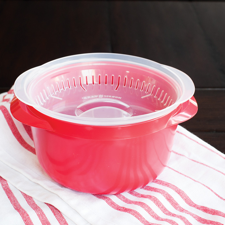Nordic Ware white plastic multi-boiler with clear vented lid placed upside down inside container
