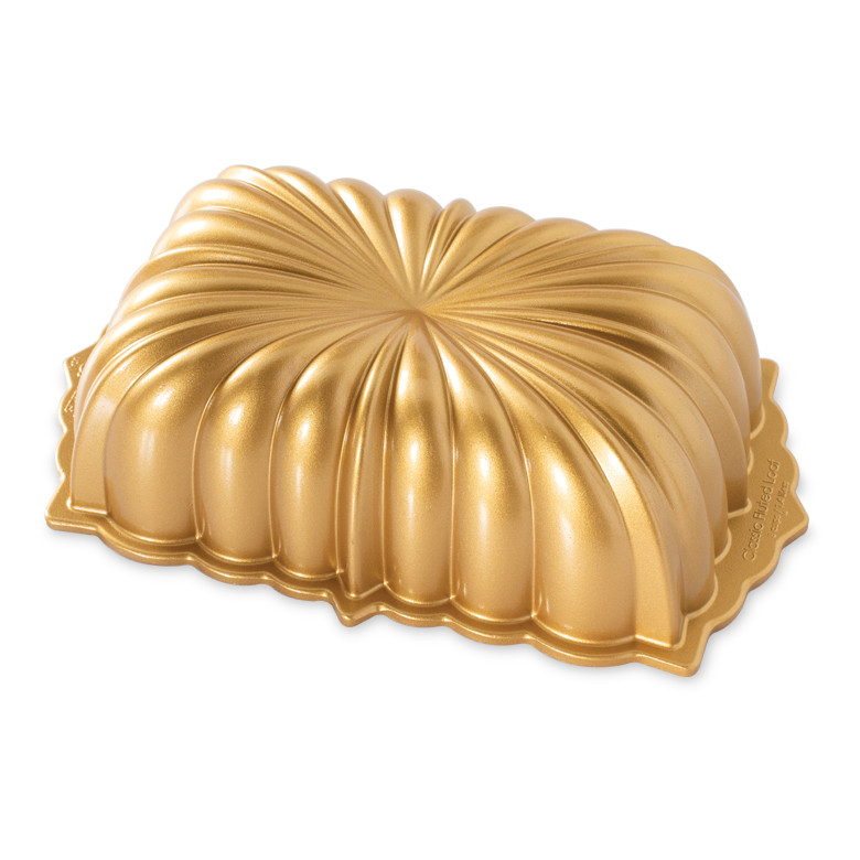 Nordic Ware aluminum fluted loaf pan with decorative ridged sides and golden nonstick interior coating