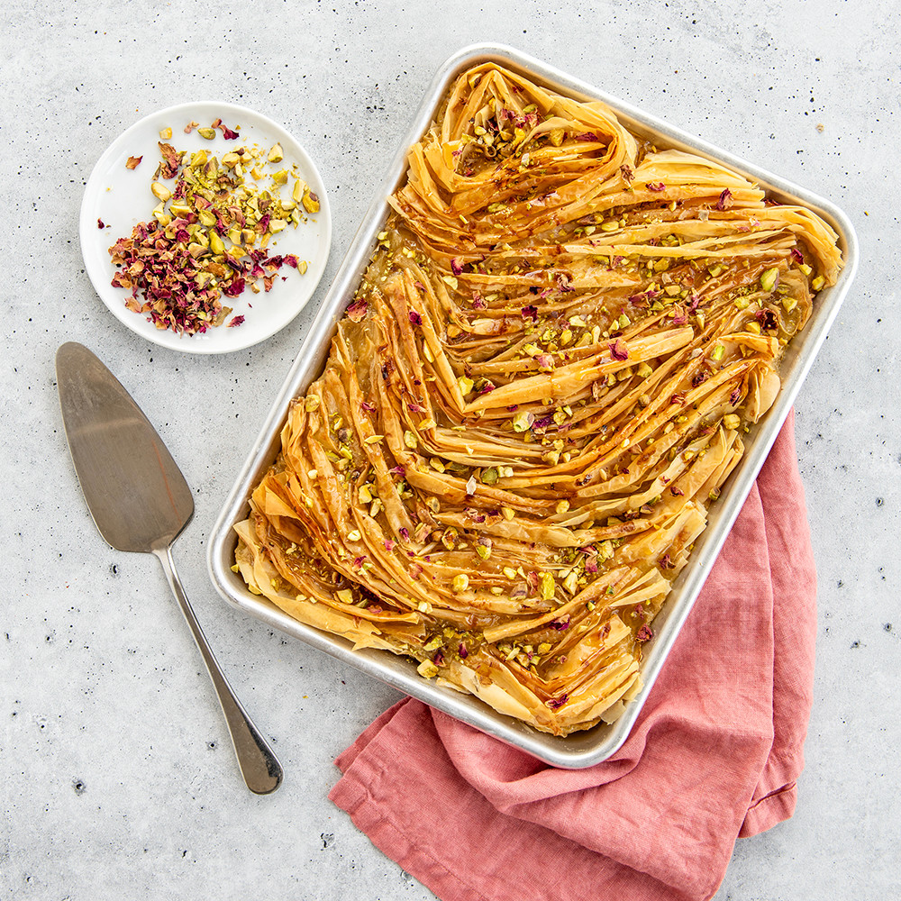Nordic Ware aluminum quarter sheet pan with golden baked baklava squares arranged in rows