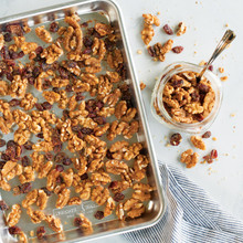 Golden roasted walnuts on Nordic Ware aluminum quarter sheet baking pan with natural silver finish