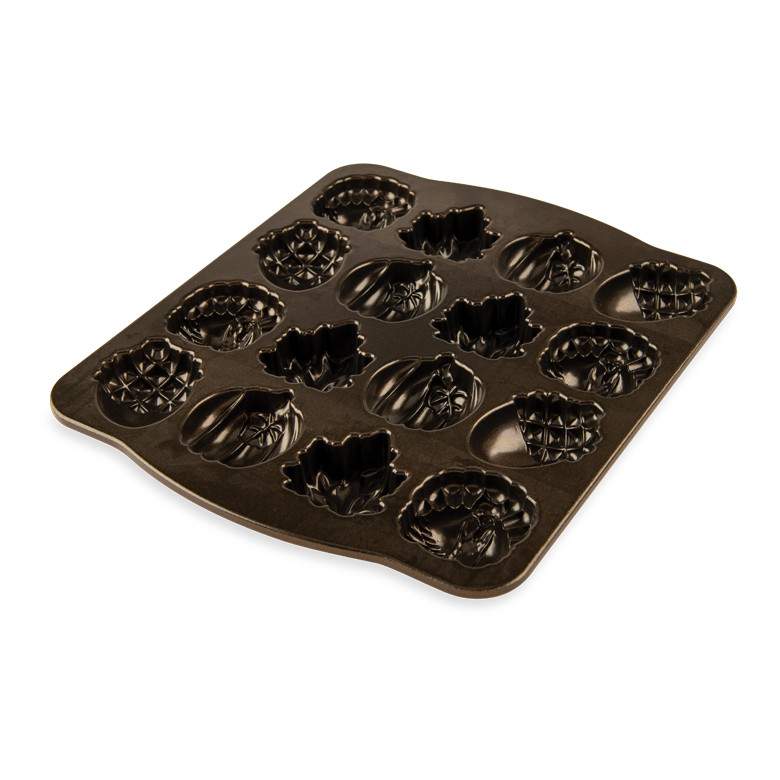 Nordic Ware Autumn Cakelet Pan showing bronze nonstick interior with six autumn-themed cavities