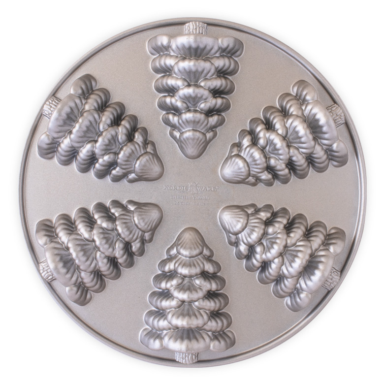 Nordic Ware aluminum cakelet pan with 6 evergreen tree-shaped cavities, silver finish