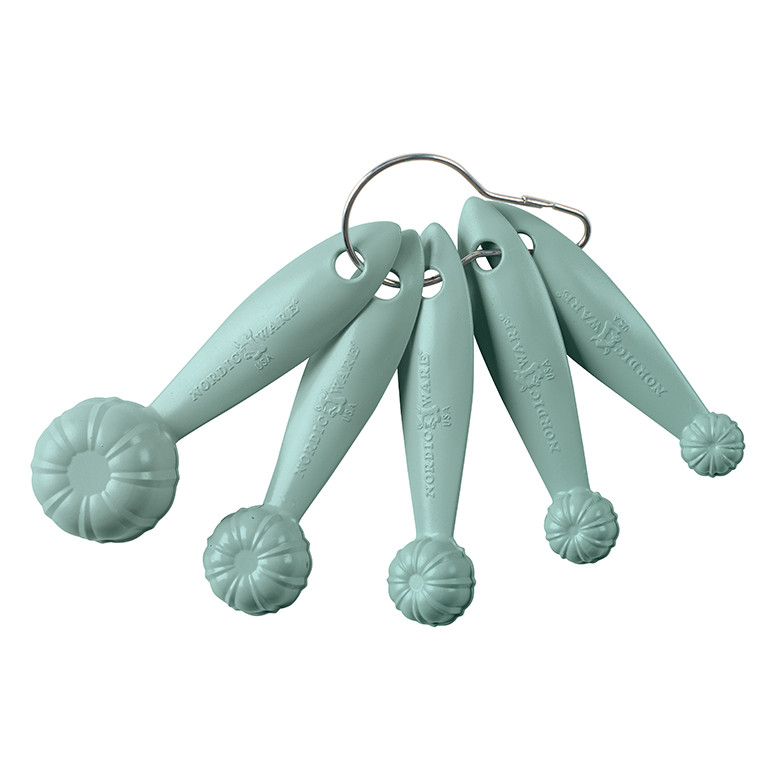 Set of 5 sea glass colored plastic measuring spoons in bundt pan shape, showing smooth backs with hanging loops