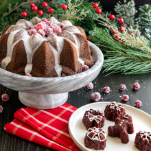 Nordic Ware aluminum Holiday Teacakes pan with baked golden cakes and Vintage Star bundt cake display