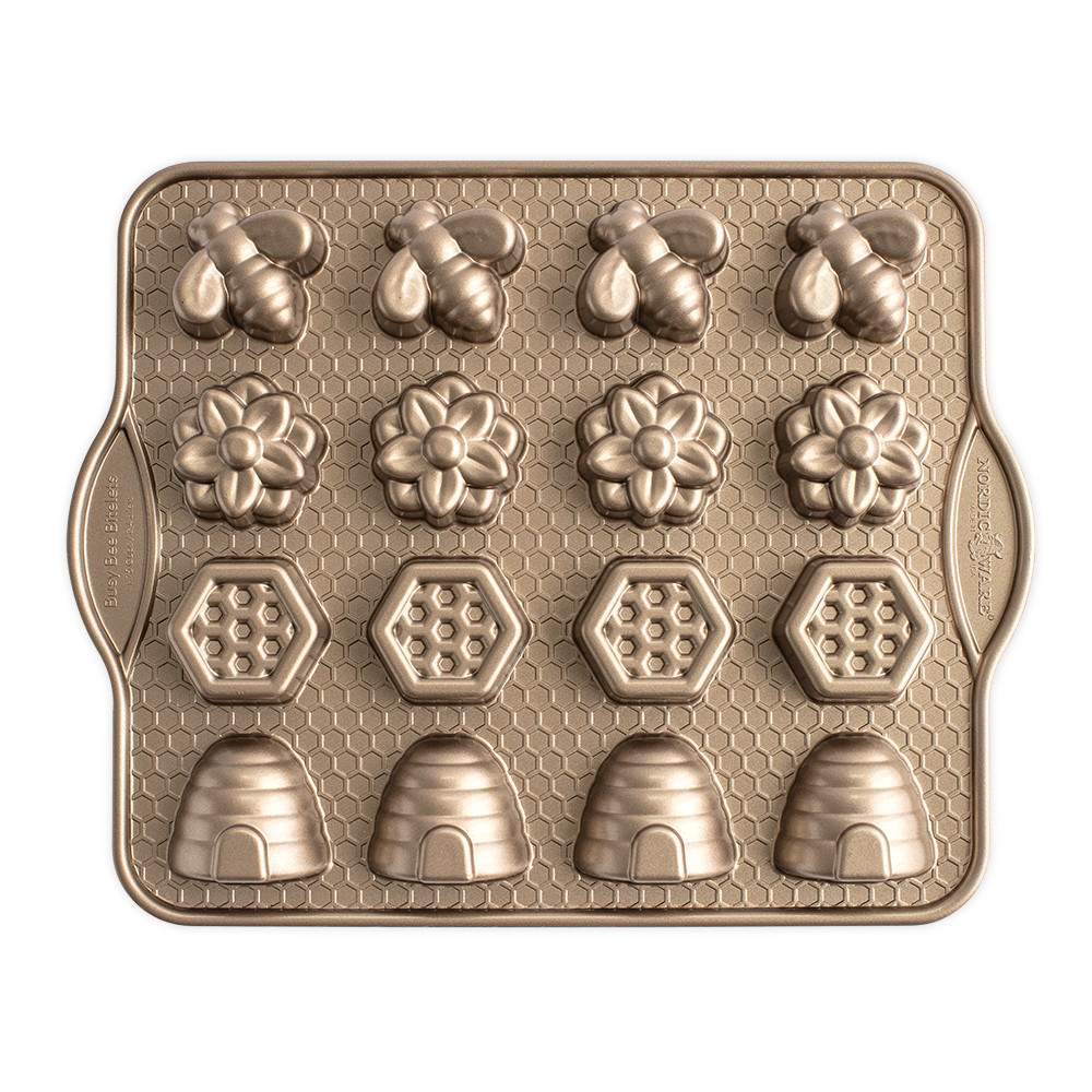 Nordic Ware aluminum bitelet pan with 16 bee-shaped cavities, toffee-colored nonstick coating, overhead view