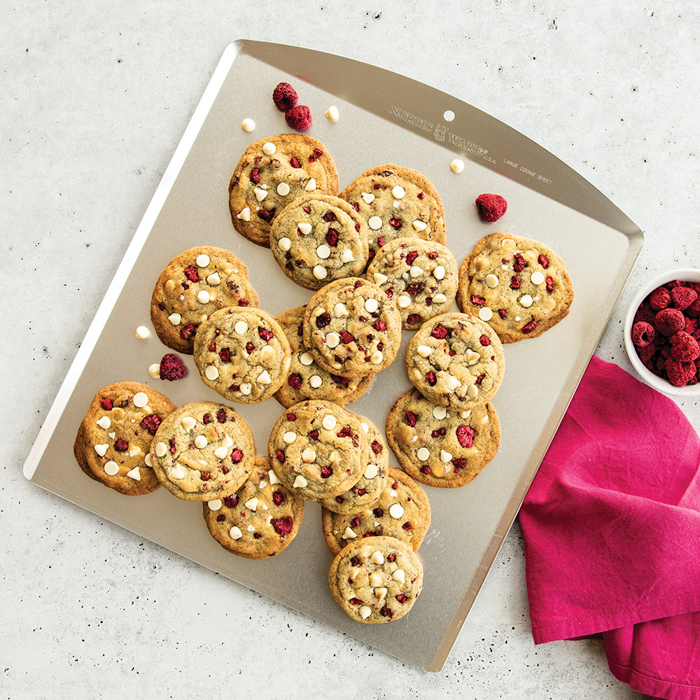 Nordic Ware aluminum cookie sheet with freshly baked golden brown cookies arranged in rows
