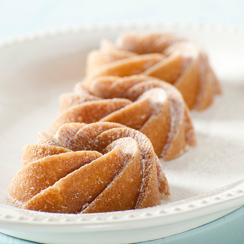 Nordic Ware Heritage Bundtlette pan with six mini bundt molds, aluminum construction, intricate fluted design