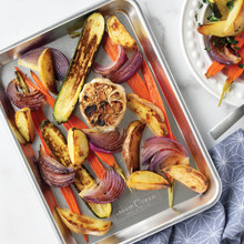 Nordic Ware aluminum quarter sheet pan with colorful roasted vegetables, natural silver finish with raised edges