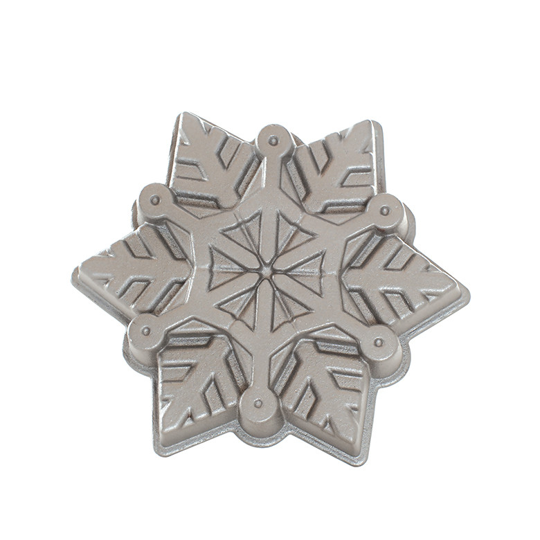 Nordic Ware aluminum snowflake-shaped baking pan with six detailed pointed sections, natural silver finish