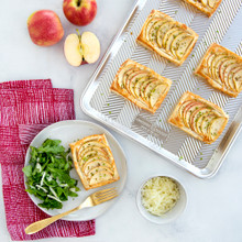 Baked apple pastries with golden crust on Nordic Ware aluminum Prism Quarter Sheet pan, silver finish