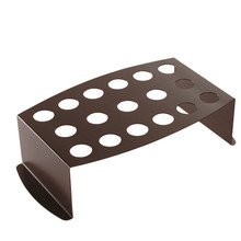 White aluminum Nordic Ware chicken leg griller with 17 vertical slots for legs and jalapeños