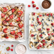 Two Nordic Ware aluminum quarter sheet pans with colorful frozen yogurt bark pieces, natural silver finish