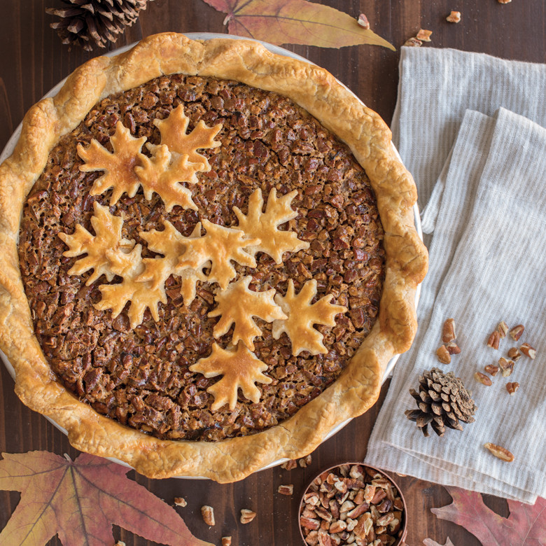 Pecan pie with decorative leaf-shaped pastry cutouts on golden crust, made using Nordic Ware pie cutter