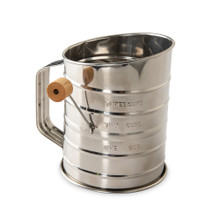 Nordic Ware aluminum flour sifter with black handle, wooden knob lever, and measurement markings on side