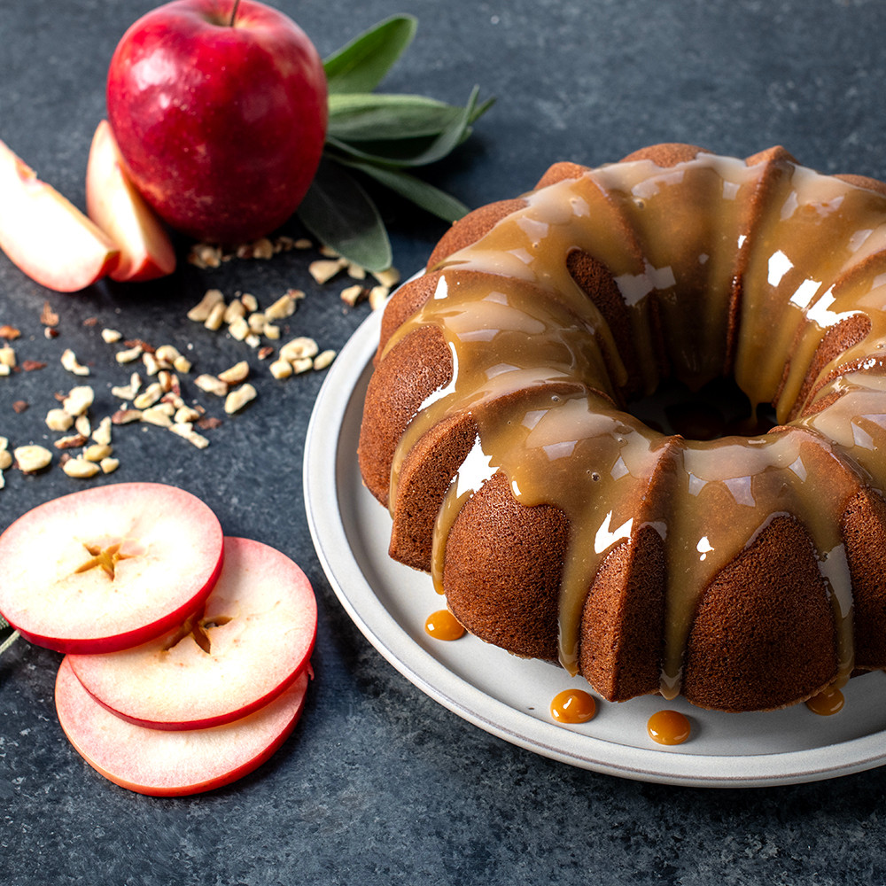 Golden caramel apple bundt cake in Nordic Ware Anniversary bundt pan showing detailed fluted design