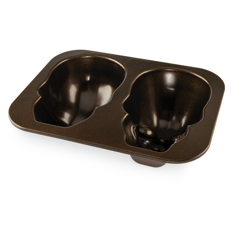 Nordic Ware Haunted Skull cake pan interior view showing two large skull-shaped cavities with bronze nonstick coating