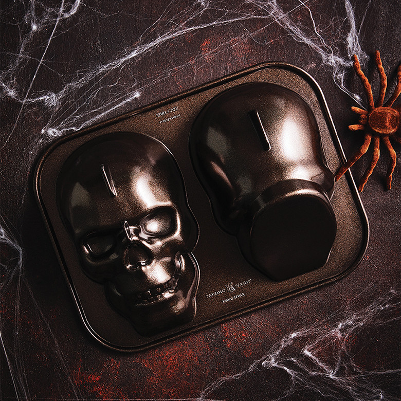 Nordic Ware aluminum haunted skull cake pan, dark gray finish, showing detailed bone structure and eye sockets