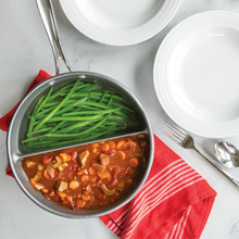 Nordic Ware divided sauce pan with beef stew in one section and green beans in the other, overhead view