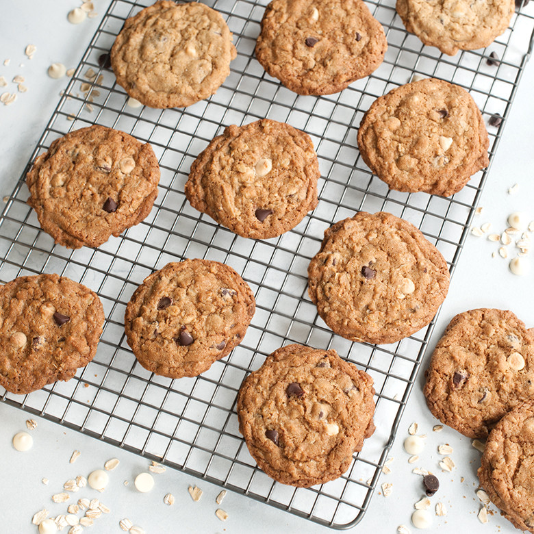 Golden baked cookies cooling on Nordic Ware nonstick grid rack over aluminum half sheet pan
