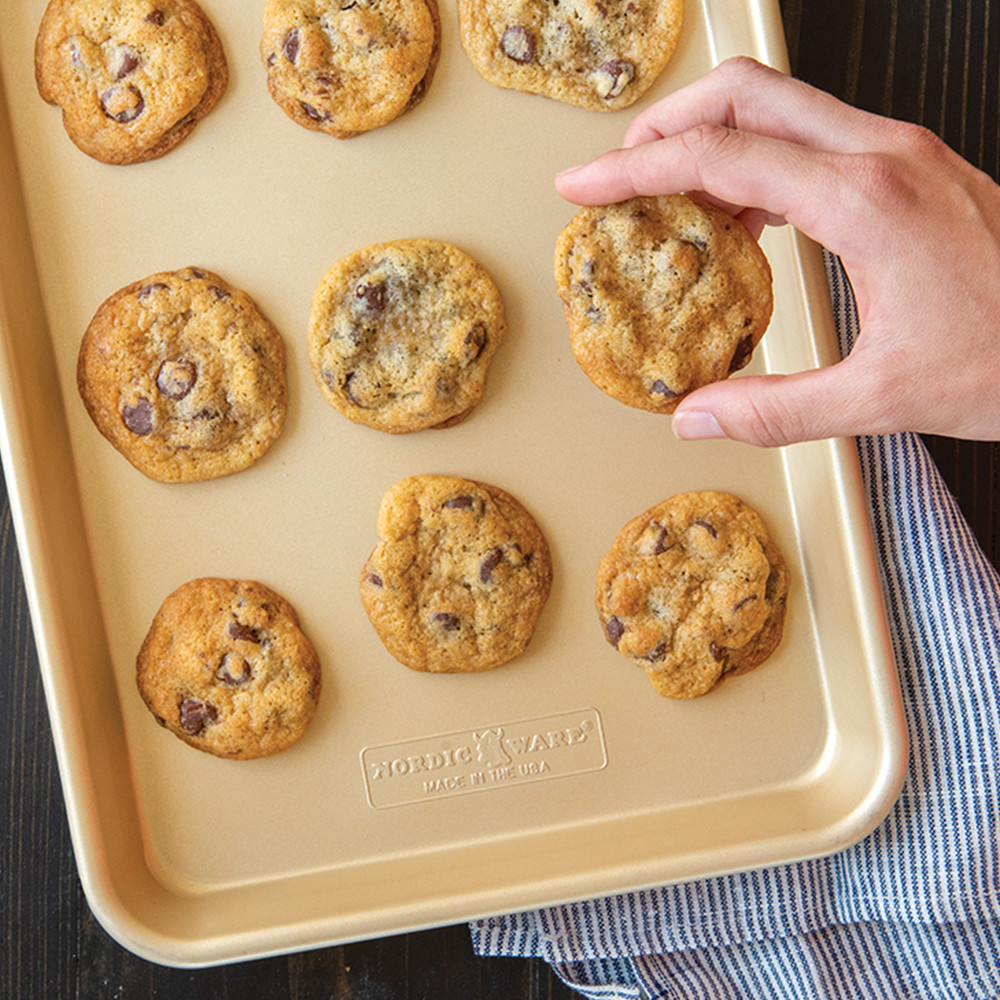 Golden baked cookies arranged on Nordic Ware aluminum quarter sheet pan with natural finish