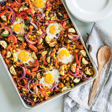 Golden breakfast hash with diced potatoes, peppers, and eggs baked on Nordic Ware aluminum half sheet pan