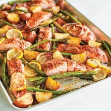 Nordic Ware aluminum half sheet pan with roasted salmon fillets, asparagus, cherry tomatoes, and lemon slices