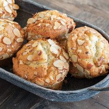 Twelve golden brown muffins baked in Nordic Ware Naturals aluminum muffin pan with natural finish