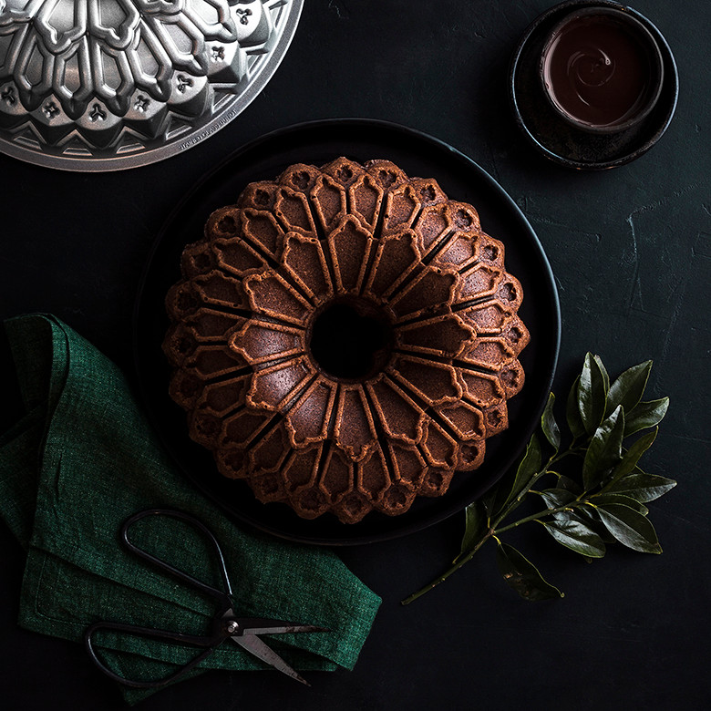 Chocolate bundt cake with decorative geometric pattern baked in Nordic Ware Stained Glass bundt pan, dark aluminum finish