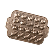 Nordic Ware aluminum cakelet pan with 20 vegetable-shaped cavities: cabbages, pea pods, radishes, and carrots