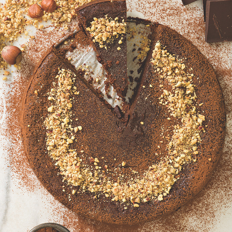 Chocolate hazelnut torte with nuts on top baked in Nordic Ware 9-inch springform pan, golden brown crust