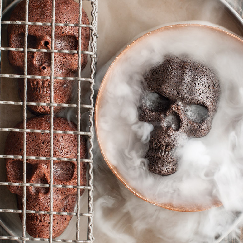Dark chocolate skull-shaped cake with dramatic smoke effects, baked in Nordic Ware Haunted Skull cakelet pan