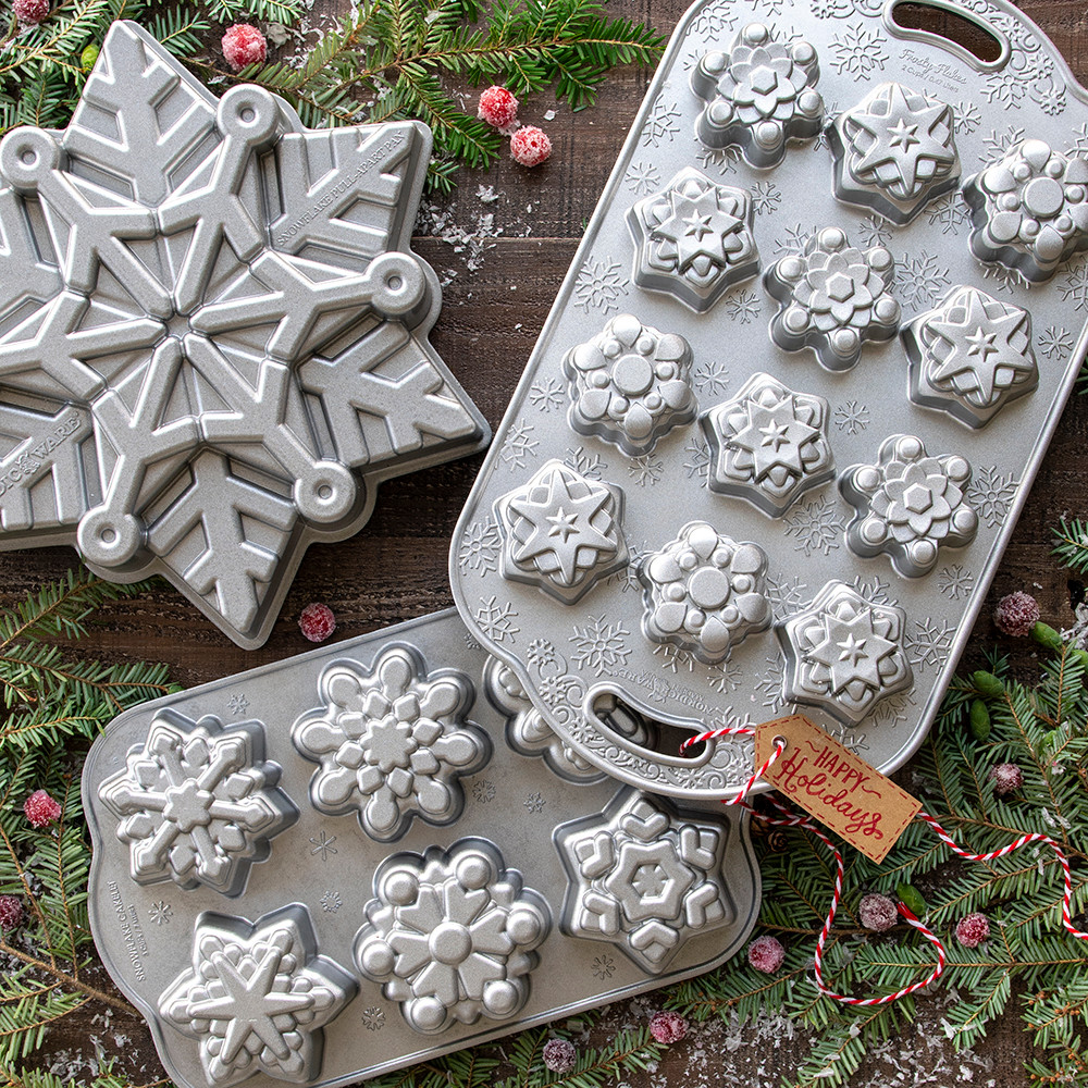 Nordic Ware aluminum snowflake cakelet pan with six detailed snowflake-shaped cavities, silver finish
