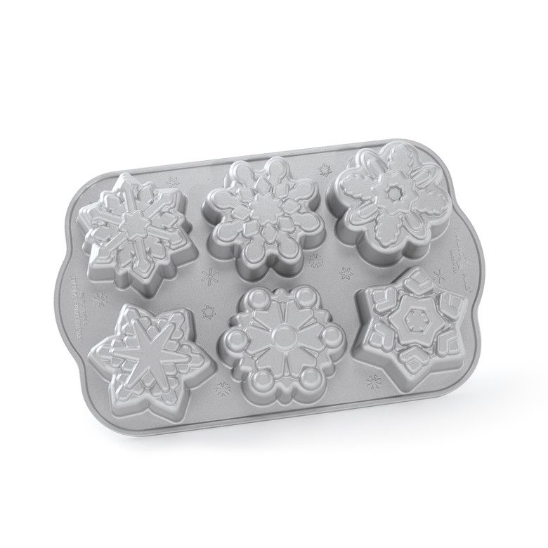 Nordic Ware aluminum snowflake cakelet pan with 6 individual detailed snowflake-shaped cavities, natural finish
