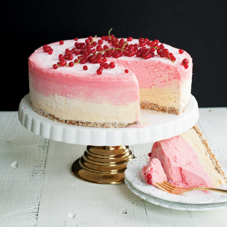 Nordic Ware 9-inch springform pan with sliced pink strawberry cheesecake, showing removable side mechanism