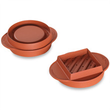 White plastic burger press showing reverse side with circular indentation and handle attachment point