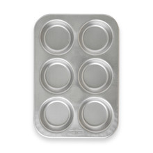 Nordic Ware Naturals aluminum jumbo muffin pan with 6 large cavities, natural silver finish, overhead view