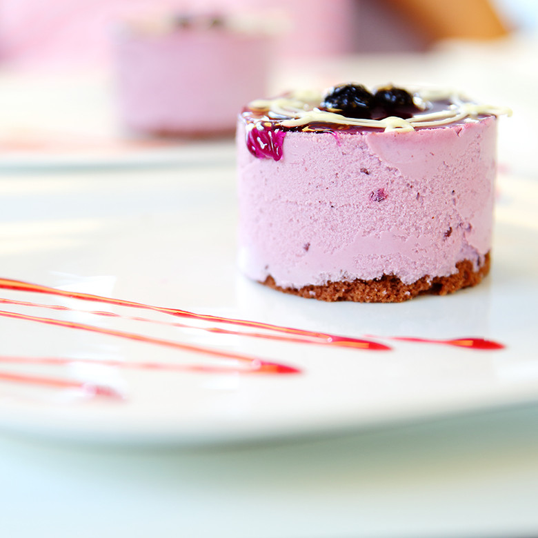 Layered raspberry dessert with graham cracker crust baked in Nordic Ware round aluminum cake pan