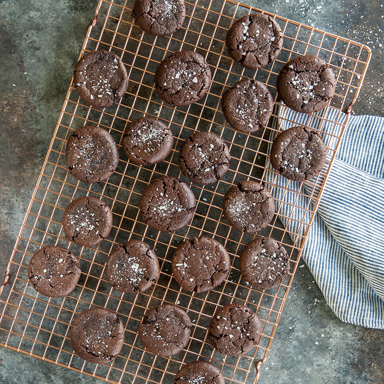 Fresh baked chocolate cookies cooling on Nordic Ware large copper-plated wire cooling rack