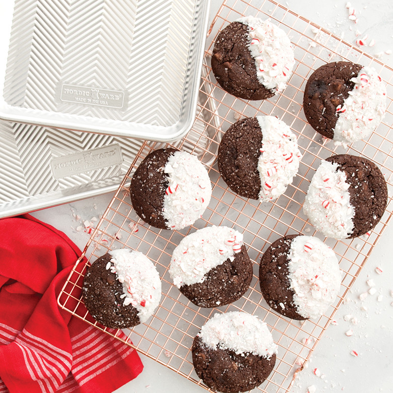 Baked chocolate chip cookies on wire cooling rack with two Nordic Ware Prism aluminum baking sheets, natural finish