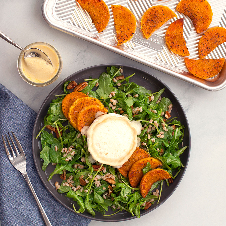 Mixed greens salad with golden roasted sweet potato slices, prepared using Nordic Ware Prism baking sheet