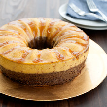 Layered chocoflan dessert baked in Nordic Ware aluminum bundt springform pan with golden caramel topping