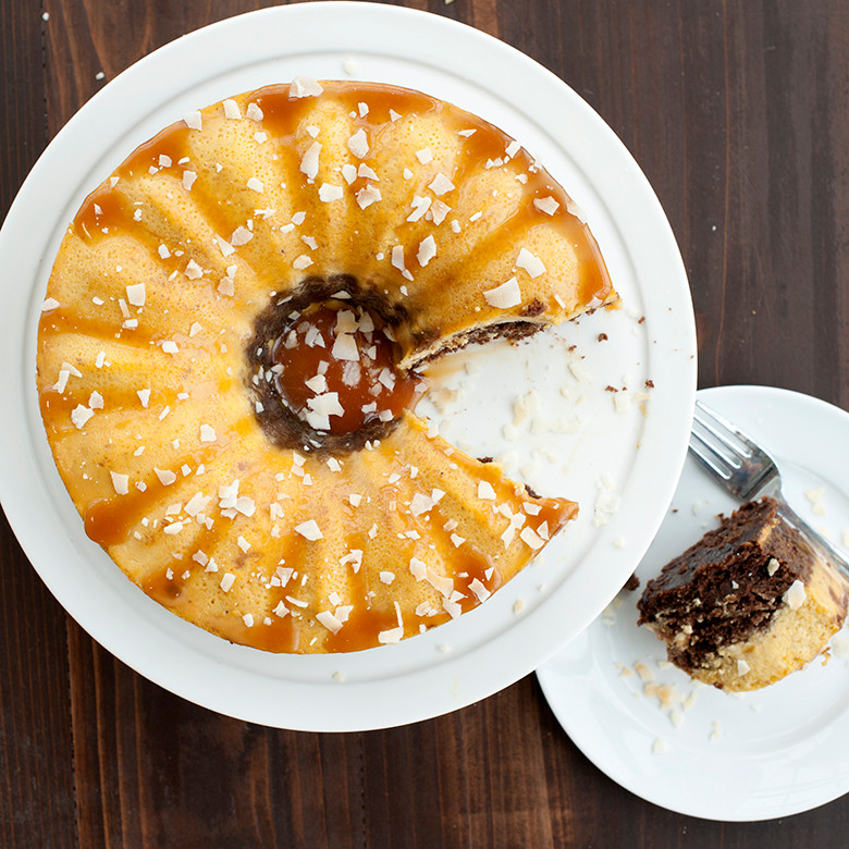 Sliced chocoflan dessert baked in Nordic Ware bundt springform pan with caramel drizzle, overhead view