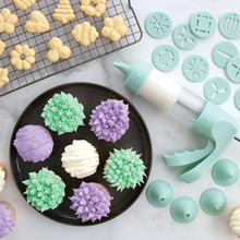 Decorated cupcakes with piped frosting and golden spritz cookies made with Nordic Ware cookie press discs