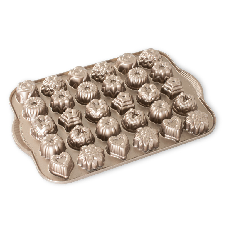 Nordic Ware aluminum baking pan with 6 mini bundt-shaped cavities, silver finish, fluted design details