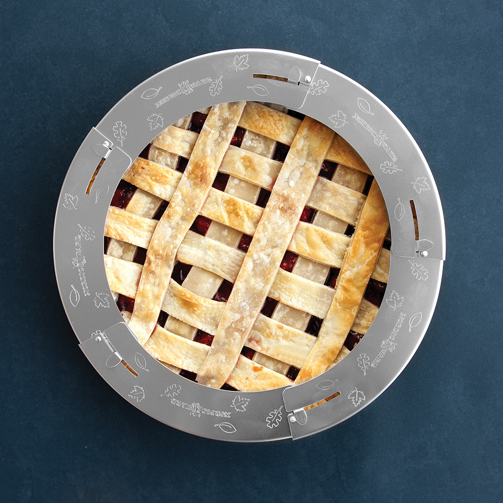 Nordic Ware silver aluminum adjustable pie crust shield placed on golden lattice-topped pie