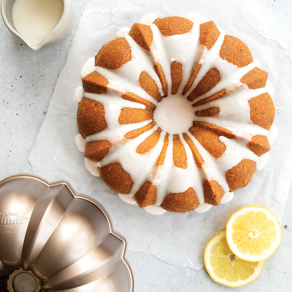 Glazed lemon bundt cake in Nordic Ware Toffee Original aluminum bundt pan with classic fluted design