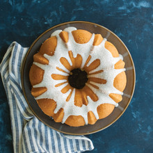 Nordic Ware aluminum bundt pan with classic fluted design, showcasing glazed golden cake with detailed ridges